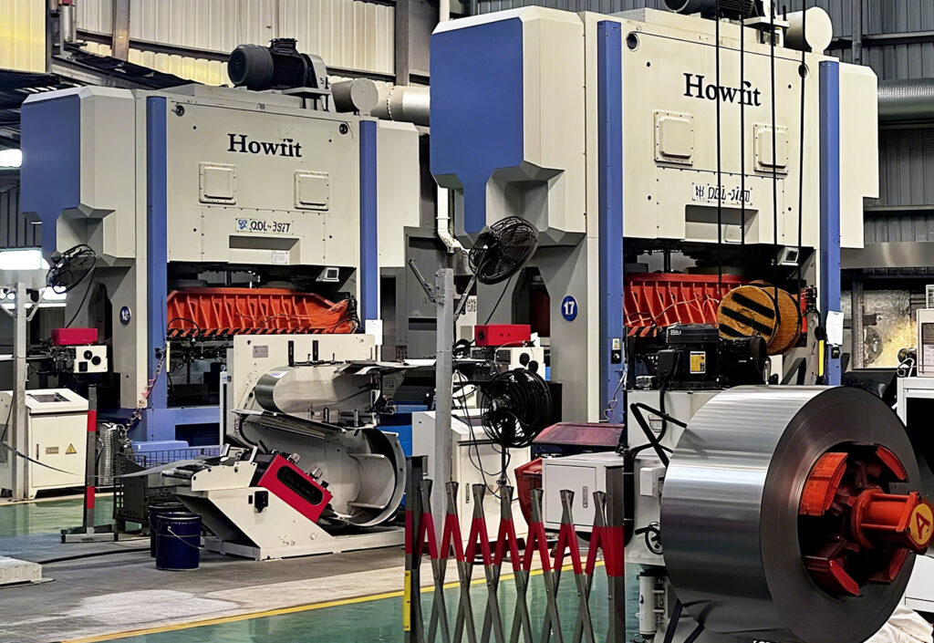 Heavy-duty stamping press machine in DAYOU TECH factory workshop for motor housing production.