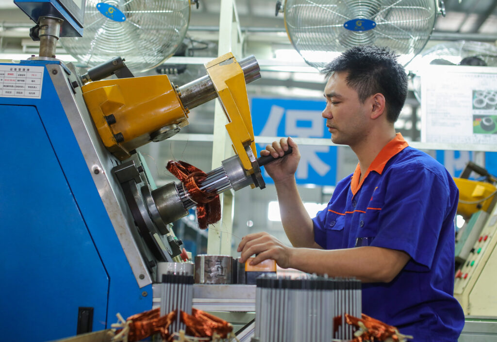 DAYOU TECH technician operating motor winding machine in the workshop