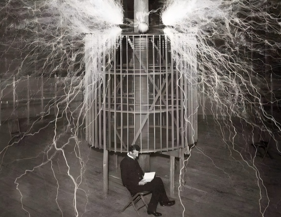 In 1899, Tesla was in his laboratory in Colorado Springs, with his invention, the "magnifying emitter," in the background.